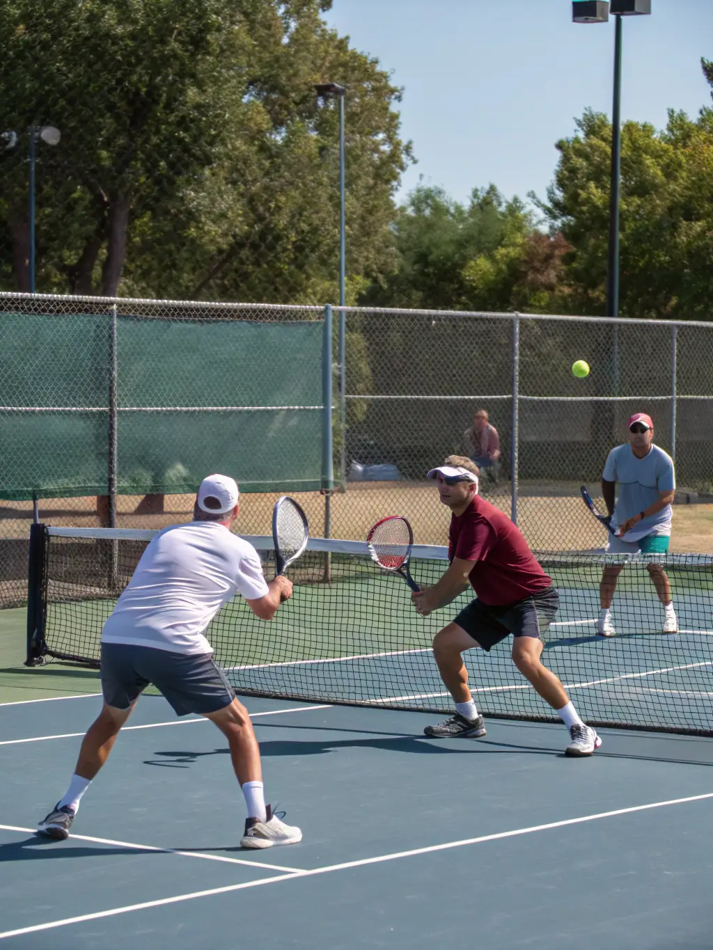 An image of adult players engaged in a competitive doubles match during a CMTC-organized tournament.